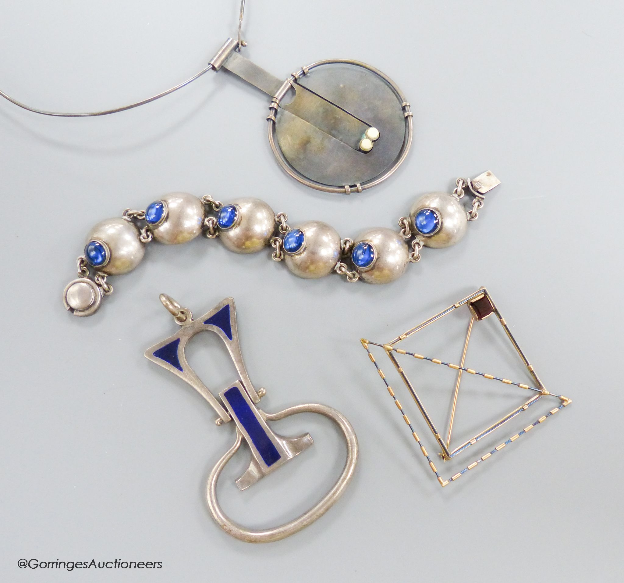 A stylish 1970's silver and blue enamel set pendant, maker E&N?, 78mm, gross 45.2 grams, a Scandinavian? 925 pendant necklace, a modernist square brooch and a blue paste and white metal bracelet.